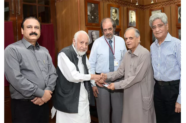 prof zaheer ahmed siddiqui handing over the cheque to vice chancellor hassan amir shah during a ceremony held at the syndicate committee room photo express prof zaheer ahmed siddiqui handing over the cheque to vice chancellor hassan amir shah during a ceremony held at the syndicate committee room photo express