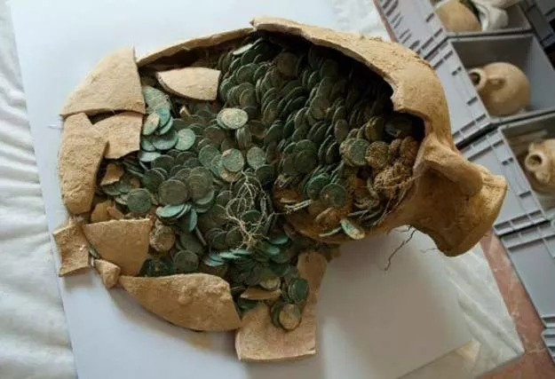 a roman era amphora filled with bronze coins is displayed at the archaeological museum in sevilla on april 28 2016 following their discovery during development works for pipelines in seville spain photo afp a roman era amphora filled with bronze coins is displayed at the archaeological museum in sevilla on april 28 2016 following their discovery during development works for pipelines in seville spain photo afp