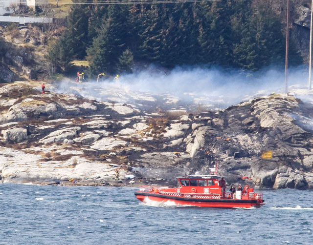 rescuers work at a site where a helicopter has crashed west of the norwegian city of bergen april 29 2016 photo reuters