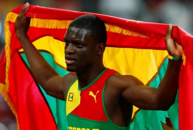 kirani james of grenada holds his national flag after placing third in the men 039 s 400 metres final at the iaaf world championships at the national stadium in beijing china august 26 2015 photo reuters
