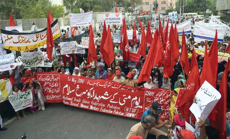 pakistani labour rights activists under the banner of national trade union federation and home based women workers federation shout slogans and wave placards as they march during a rally from empress market to karachi press club on may day on sunday photo afp