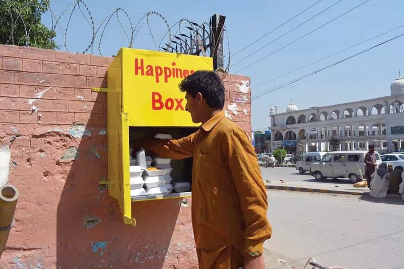 a box of happiness inscribed in a wall on university road in the city photo express a box of happiness inscribed in a wall on university road in the city photo express