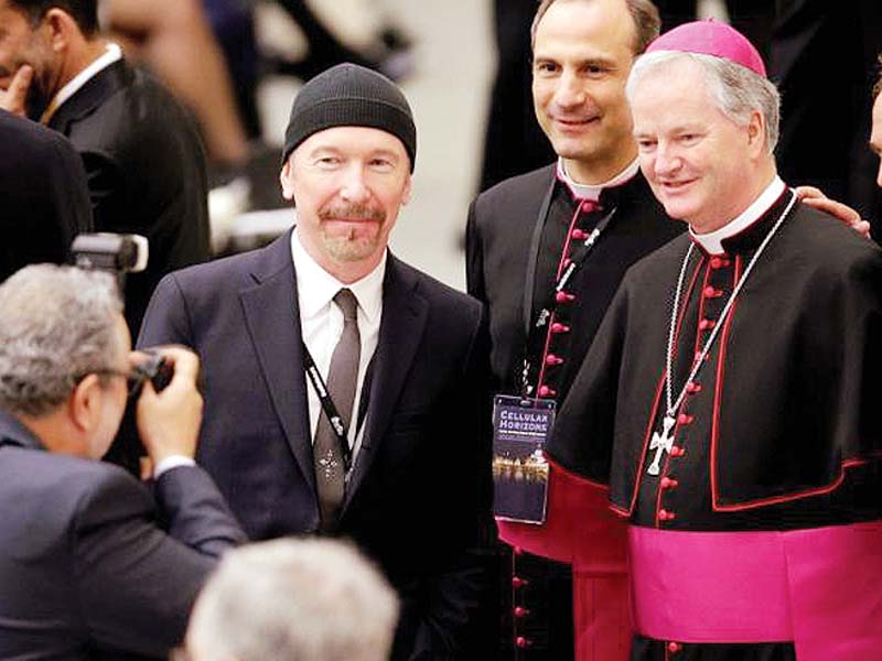 u2 guitarist david evans also known by his stage name the edge poses with irish bishop paul tighe r photo file