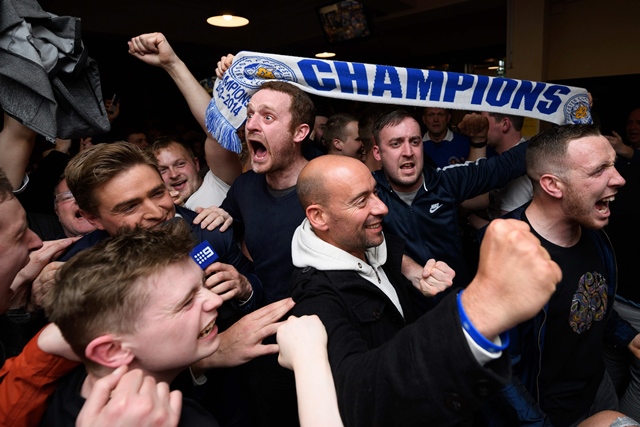 leicester city fans celebrate winning the premier league at the final whistle of the english premier league football match between chelsea and tottenham hotspur in a pub in central leicester england on may 2 2016 photo afp