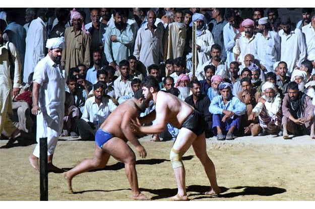 traditional wrestlers in action during 5th all punjab dangal photo app