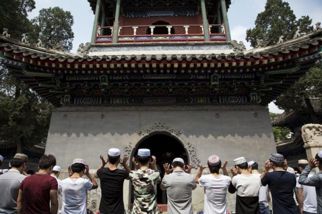 muslim believers pray at the historic niujie mosque as they celebrate the eid al fitr in beijing july 18 2015 photo reuters