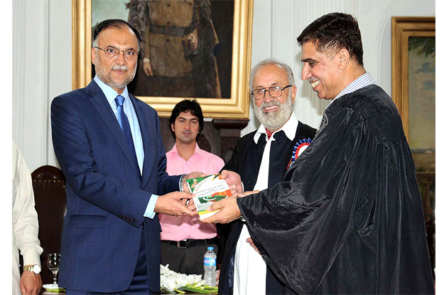 federal minister for planning national reforms and development ahsan iqbal giving shield to faculty member of islamia college during a seminar on cpec photo app