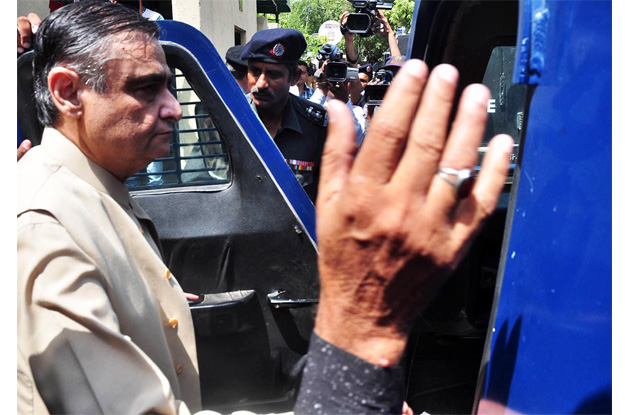 policemen bringign former petroleum minister dr asim hussain for a hearing at nab court photo online