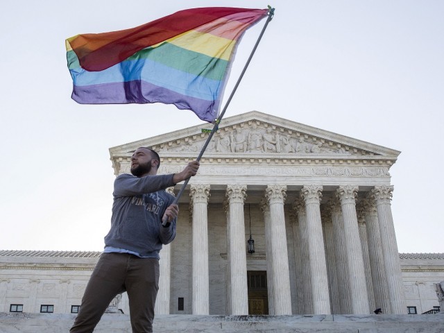 vin testa of washington dc waves a gay rights flag in front of the supreme court before a hearing about gay marriage in washington in an april 28 2015 file photo photo reuters