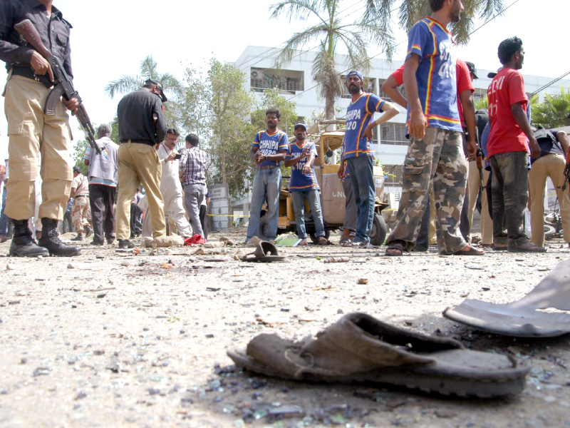 security officials inspect the site of the bomb blast in clifton photo muhammad saqib express