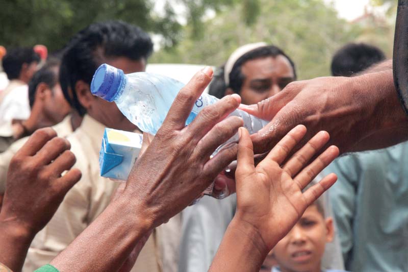 water bottles and juices were handed out by volunteers during the heatwave in karachi last year photo file
