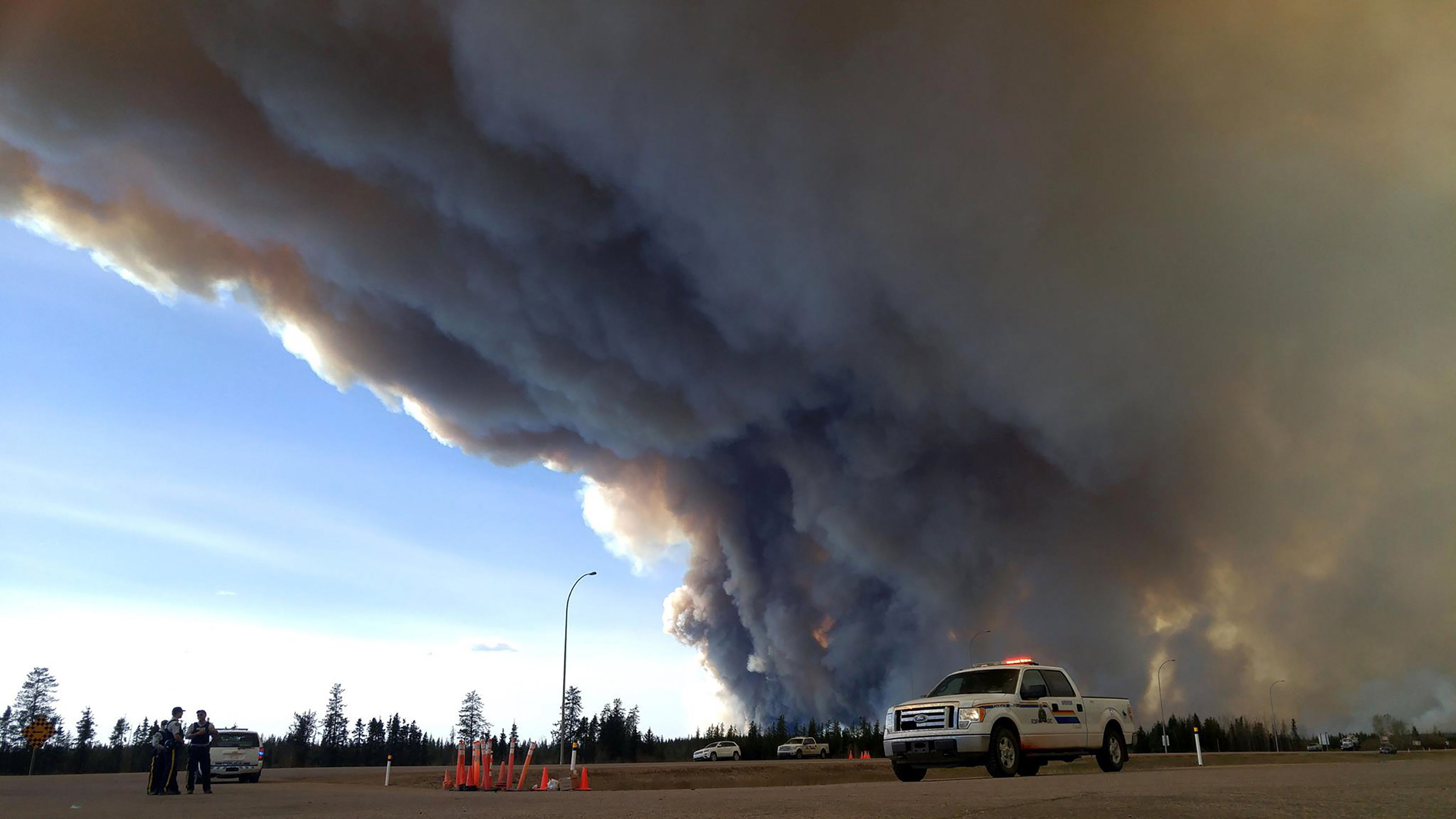 weather aids firefighters battling blaze in canada oil region
