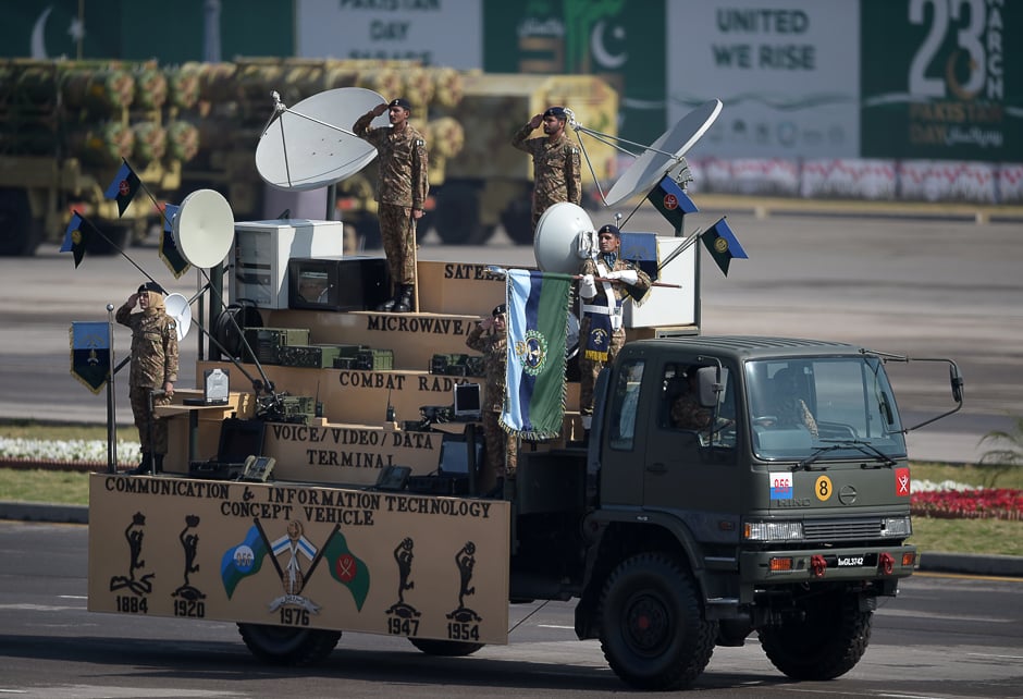 Military personnel salute as they take part in a Pakistan Day military parade in Islamabad. PHOTO: AFP