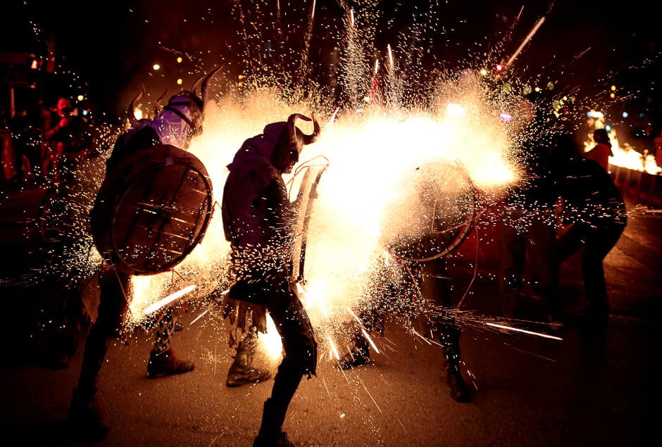 Revellers walk among fireworks during 