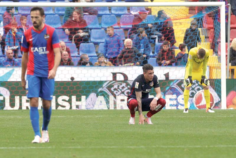 atletico s players look downcast as defeat against levante means they can no longer win la liga photo afp