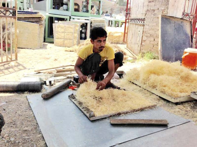 a man fixes plastic husk in the side portion of an air cooler in the city photo express