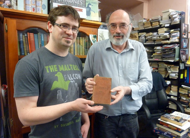 this handout photo taken and received on may 10 2016 by cracked and spineless new and used books shows bookshop owners richard sprent l and mike gray l with the diary of british lieutenant colonel john squire who served with the duke of wellington which was discovered among a pile of books in a cupboard at the cracked and spineless new and used bookstore in the tasmanian capital hobart photo afp