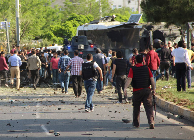 plainclothes police officers and security officers gather at the scene following a car bomb attack on a police vehicle in the kurdish dominated southeastern city of diyarbakir turkey may 10 2016 photo reuters