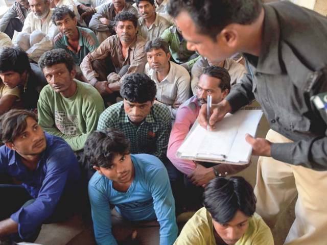 in this file photo a policeman collects data of arrested indian fishermen at the docks police station in karachi photo afp