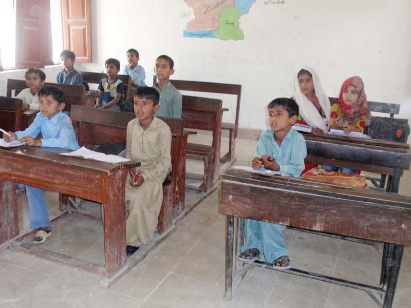 most of the classrooms are empty while a few students study in the corridor photos express