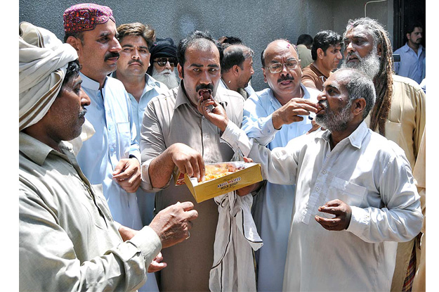 ppp workers distributing sweets to celebrate recovery of syed ali haider gillani photo app