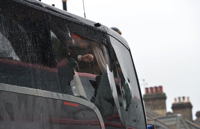 the bus carrying the manchester united team is escorted by police after having a window smashed on its way to west ham 039 s boleyn ground photo afp