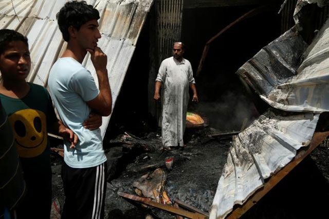 people gather at the scene of a car bomb attack in baghdad 039 s mainly shia district of sadr city iraq may 11 2016 photo reuters