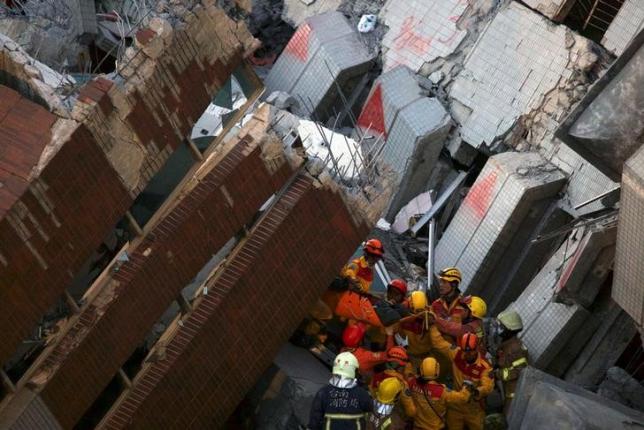 rescuers carry a survivor out from the site where a 17 storey apartment building collapsed after an earthquake hit tainan southern taiwan february 8 2016 photo reuters