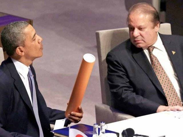 president barack obama and prime minister nawaz sharif look at a gift as they attend nuclear summit in the hague photo afp file