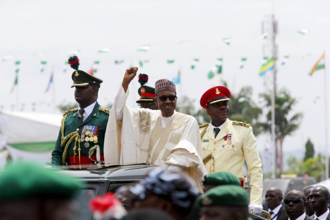 nigeria 039 s new president muhammadu buhari rides on the motorcade while inspecting the guard of honour at eagle square in abuja nigeria may 29 2015 photo reuters