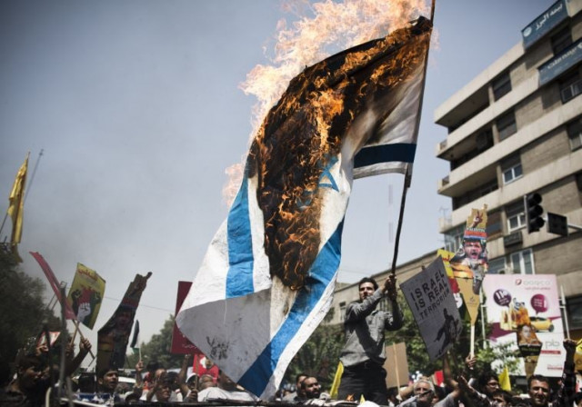 iranian protestors burn an israeli flag during a demonstration in tehran on july 25 2014 to mark the quds day photo afp iranian protestors burn an israeli flag during a demonstration in tehran on july 25 2014 to mark the quds day photo afp