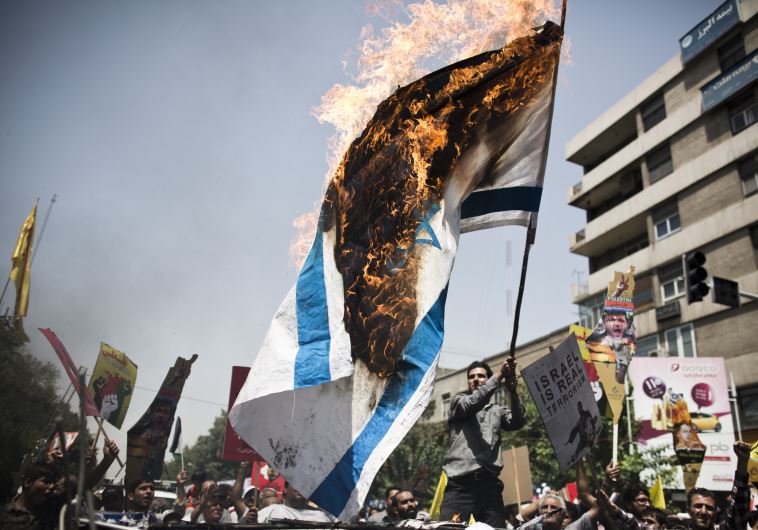 iranian protestors burn an israeli flag during a demonstration in tehran on july 25 2014 to mark the quds day photo afp