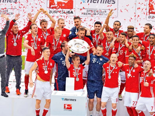 bayern munich skipper philipp lahm holds aloft the trophy as the bavarians celebrate their record fourth successive bundesliga title photo afp bayern munich skipper philipp lahm holds aloft the trophy as the bavarians celebrate their record fourth successive bundesliga title photo afp