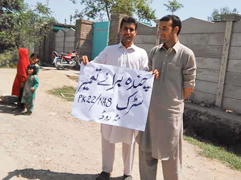 protesters block the road and hold banner in favour of their demands photos express