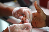 a medical technician draws a blood sample to screen for glucose and cholesterol at a free health screening photo reuters