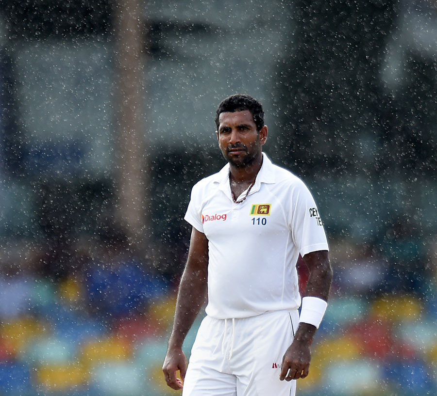 dhammika prasad looks on amidst rain in colombo sri lanka on august 29 2015 photo afp