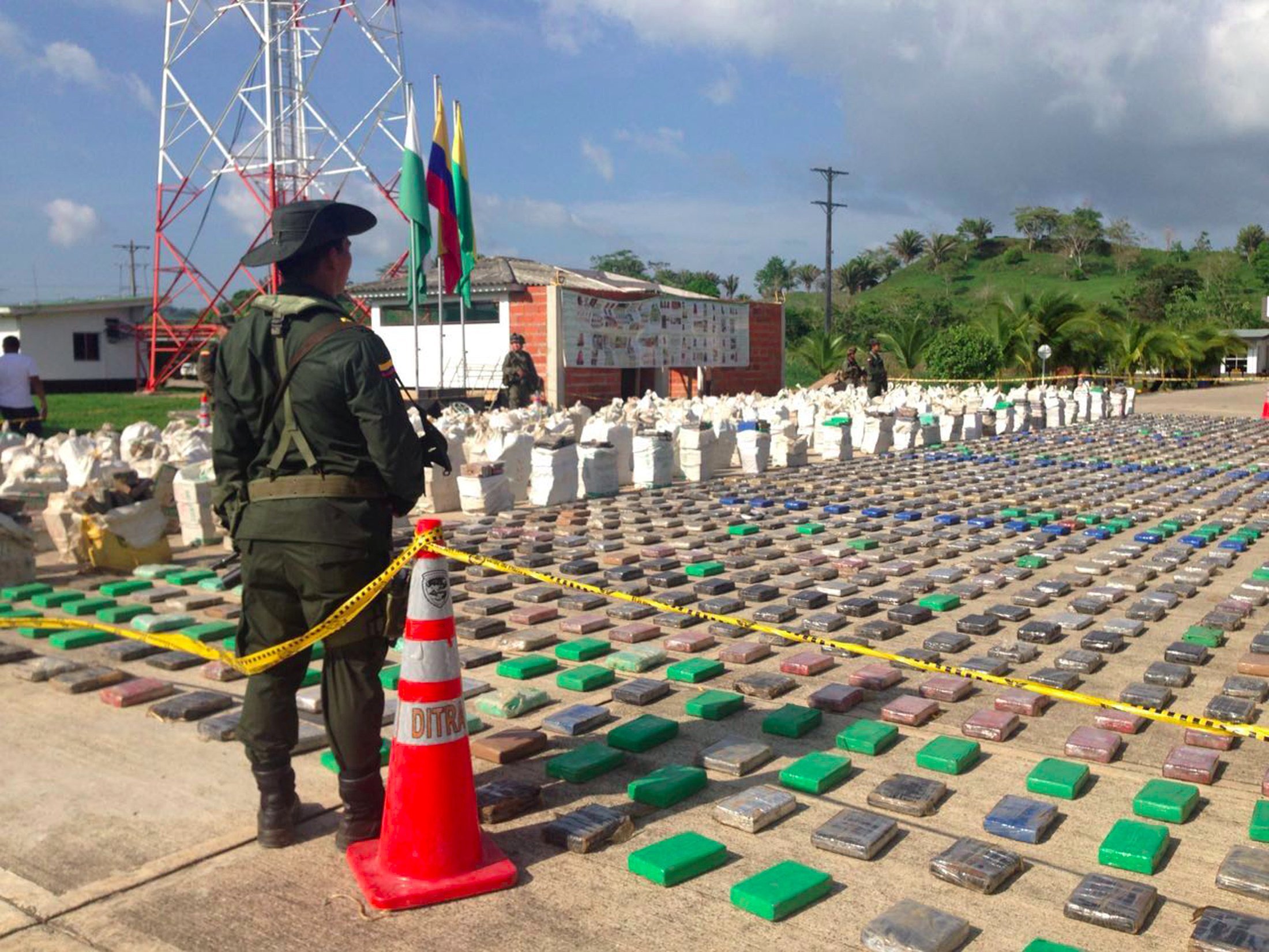 a handout picture released by the colombian police showing a colombian police officer standing guard over eight tons of seized cocaine in turbo province photo business insider