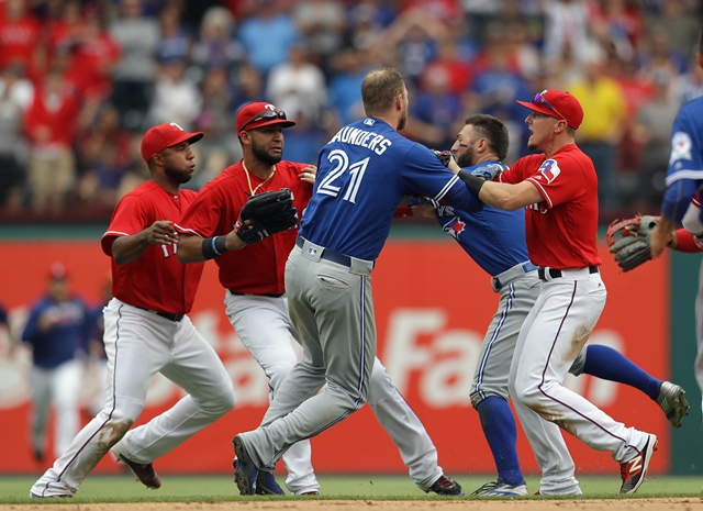 michael saunders and ryan rua push one another after the benches cleared in the eighth inning at globe life park in arlington on may 15 2016 in arlington texas photo afp