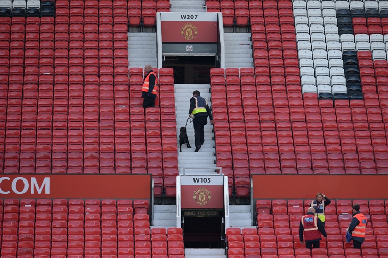 a sniffer dog searches the stands after fans evacuated old trafford stadium in manchester north west england on may 15 2016 after the english premier league football match between manchester united and bournemouth was abandoned police ordered manchester united to abandon their final premier league game of the season against bournemouth on sunday after a suspicious package was discovered at old trafford photo afp