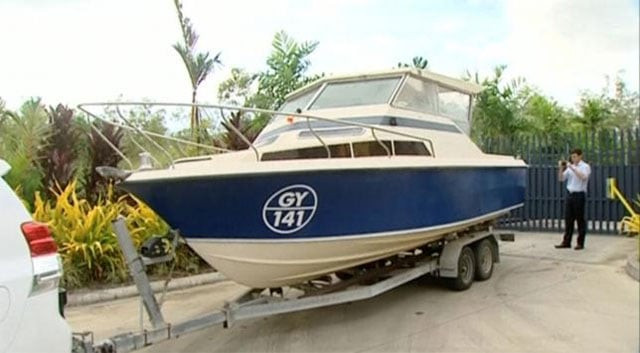 an officer takes pictures of a boat which australian police have seized in cairns queensland australia in this still image taken from video may 11 2016 photo australian broadcasting corporation handout via reuters tv an officer takes pictures of a boat which australian police have seized in cairns queensland australia in this still image taken from video may 11 2016 photo australian broadcasting corporation handout via reuters tv