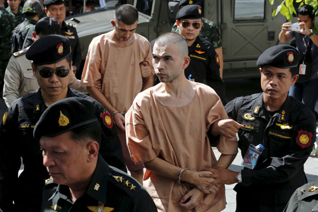 suspects of the august 17 bangkok blast bilal mohammed also known as adem karadag and yusufu mieraili are escorted as they arrive at the military court in bangkok thailand november 24 2015 photo reuters