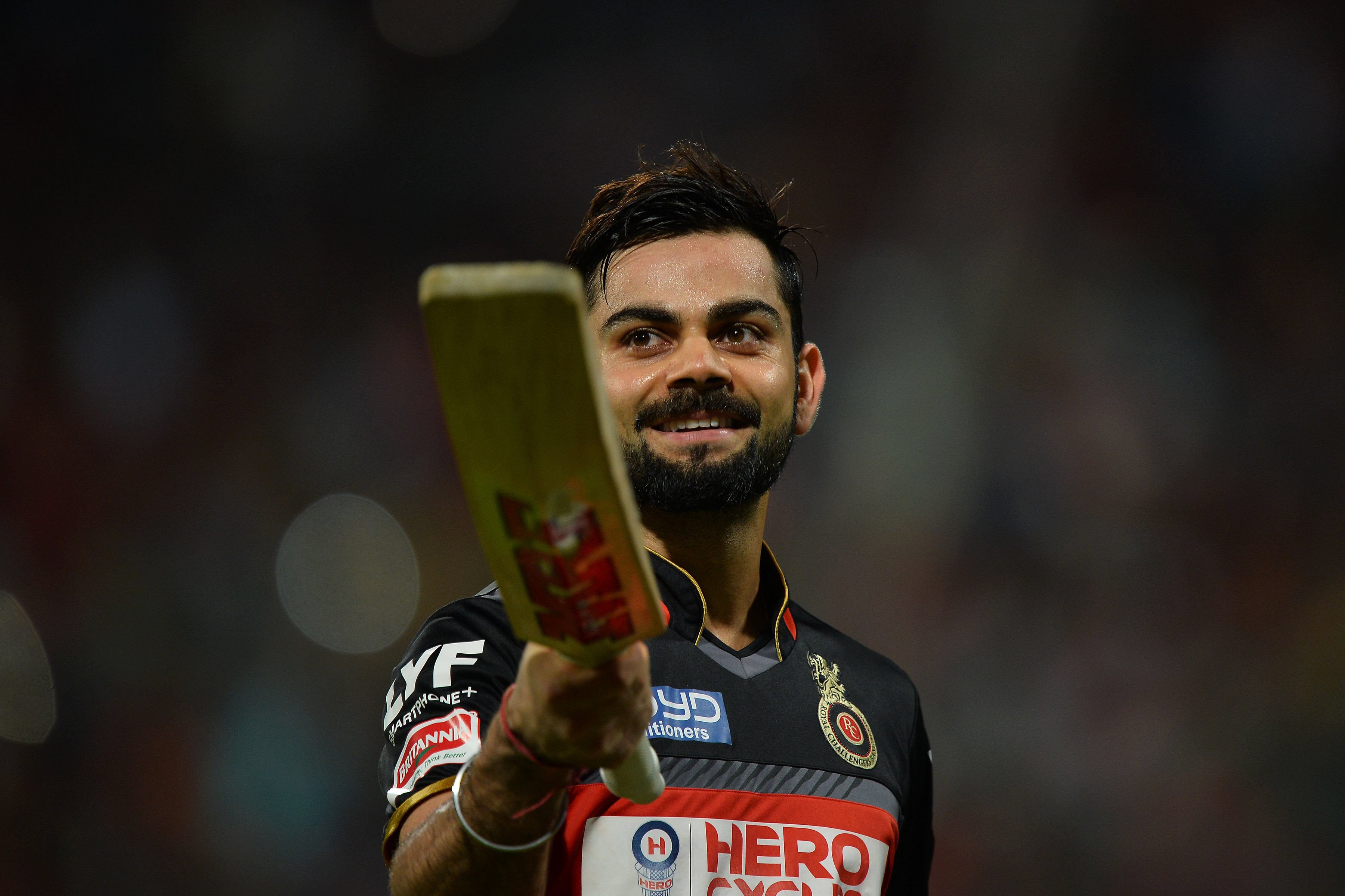 royal challengers bangalore captain and batsman virat kohli gestures to the cheering crowd as he walks back to the pavilion after being dismissed for 113 runs during the 2016 indian premier league ipl t20 cricket match between royal challengers bangalore and kings xi punjab at the m chinnaswamy stadium in bangalore on may 18 2016 photo afp