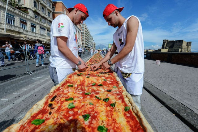 neapolitan pizza makers attempt to make the longest pizza to break a guinness world record along the seafront of naples on may 18 2016 photo afp neapolitan pizza makers attempt to make the longest pizza to break a guinness world record along the seafront of naples on may 18 2016 photo afp