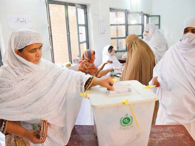 a woman casts her vote in the by polls in ariana village charsadda road photo muhammad iqbal express