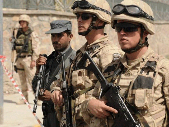 nato troops stand on guard in an fghan city photo afp