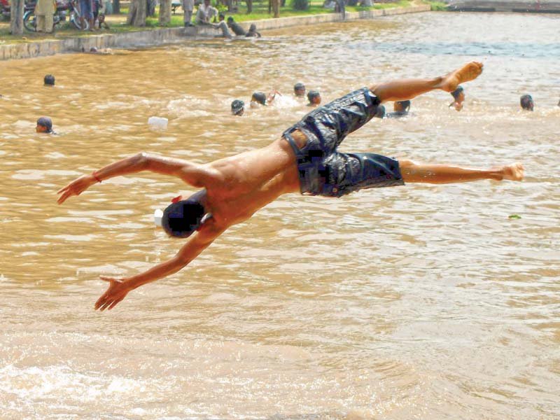 a boy dives in a canal in faisalabad to escape scorching heat pakistan remained in the grip of a heatwave with temperatures soaring above 50 degree celsius at some places photo inp