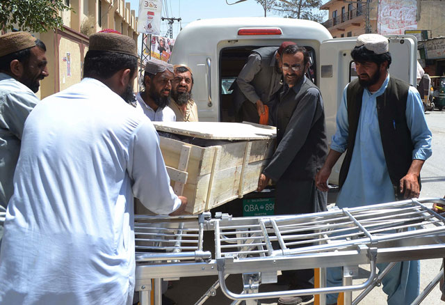 security officials and hospital staff move a dead body into a morgue in quetta on may 22 2016 photo afp