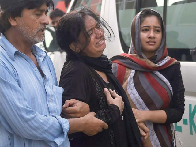 a relative of one of the slain traffic policeman mourns photo afp