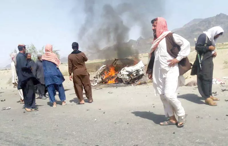 people gather around a destroyed vehicle in which mullah akhtar mansour was believed to be travelling photo afp people gather around a destroyed vehicle in which mullah akhtar mansour was believed to be travelling photo afp