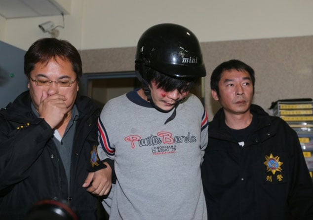 taiwanese police escort a man c who allegedly attacked and murdered a toddler on a street in taipei on march 28 2016 photo afp